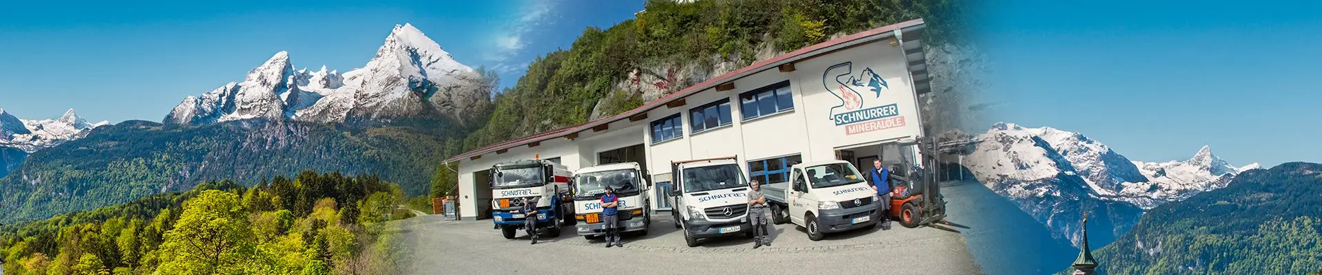 Betriebsgebäude von Schnurrer Mineralöle am Salinenplatz in Berchtesgaden mit Fuhrpark, eingerahmt von Watzmann und Hohem Göll